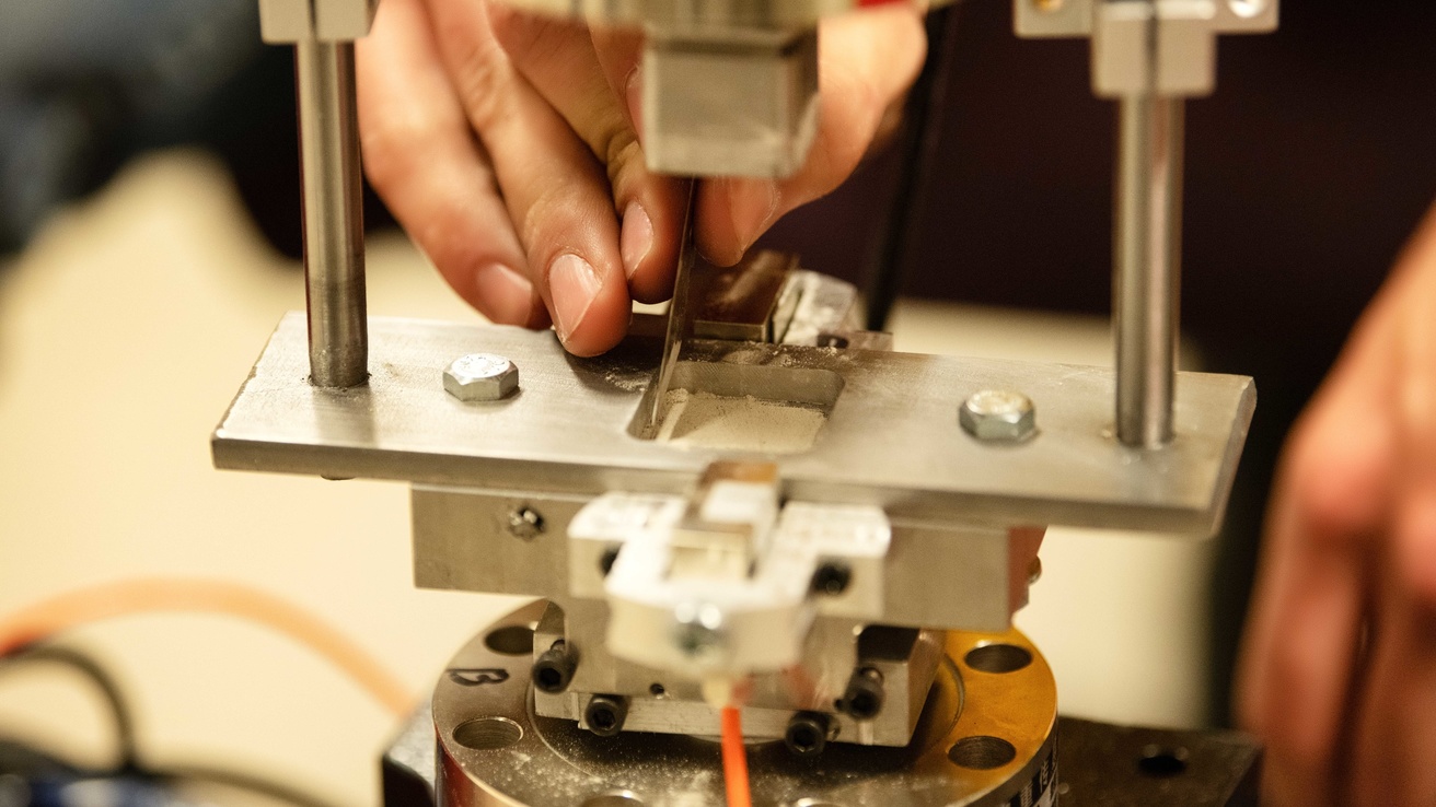 Image of hands assembling a prototype engineering device