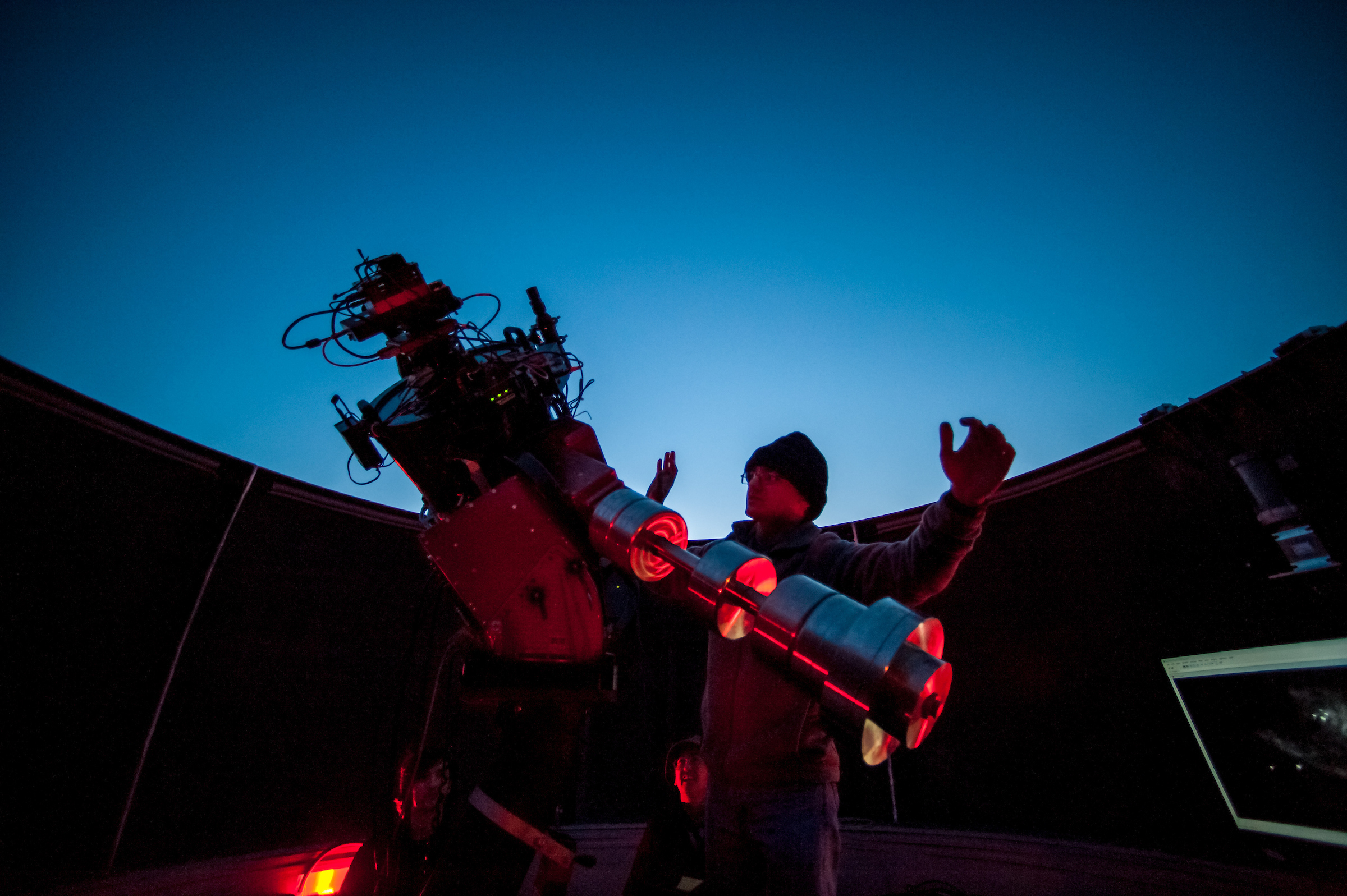 Researcher adjusting a telescope