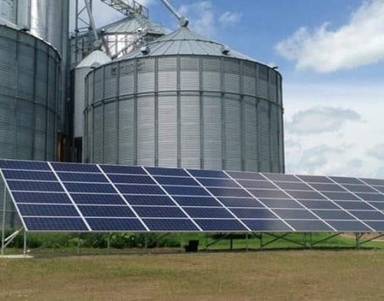 grain bin with solar panel in field