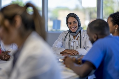 Doctor in a white lab coat and hijab