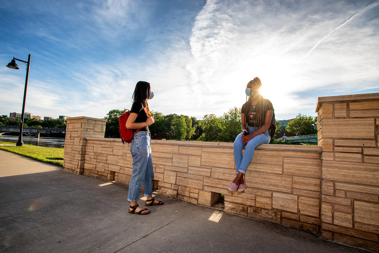 Students are outside on the University of Iowa campus wearing PPE students on campus in PPE