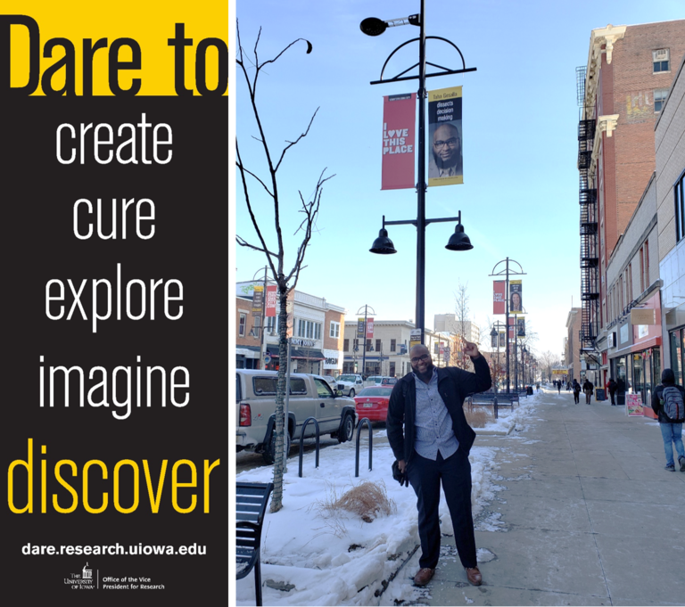 Student researcher Taha Gesalla stands under his banner in downtown Iowa City student Taha Gesalla with downtown banner