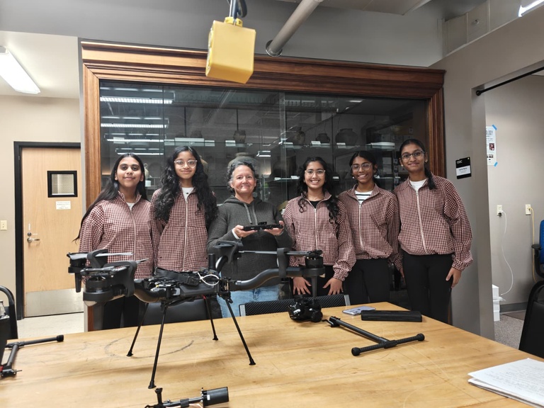 all female robotics team poses with mary de la garza