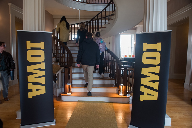 Two IOWA banners in front of the central staircase in the Old Capitol Museum