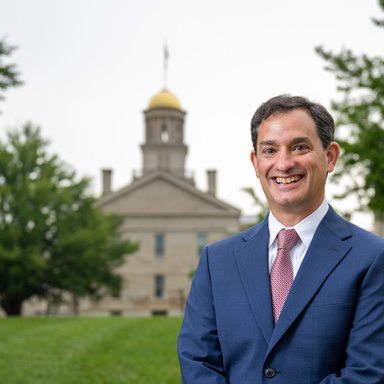 David Schwebel stands in front of the Old Capital Building. 