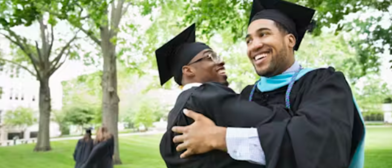 Two graduates embracing
