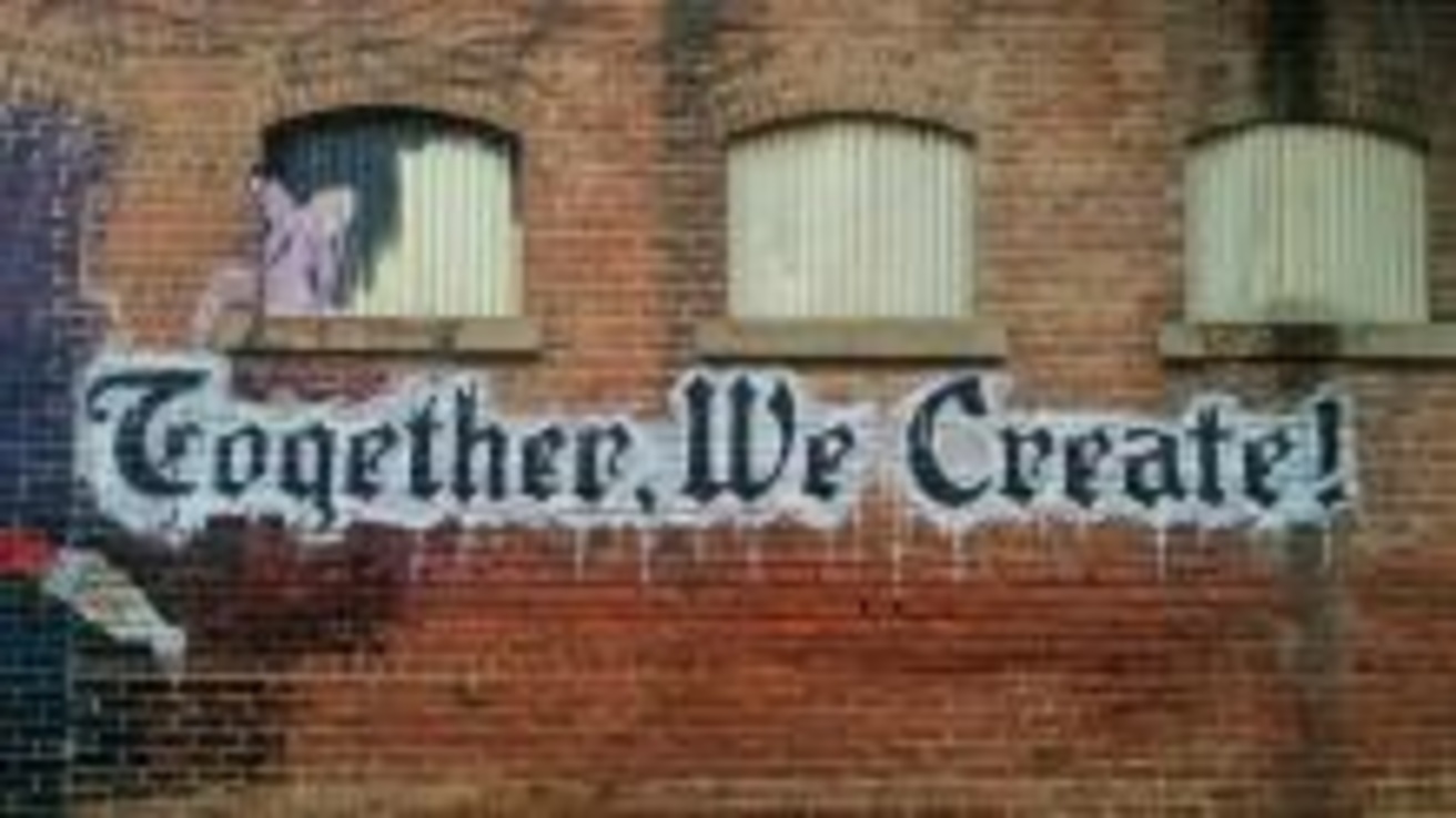 together we create on brick wall