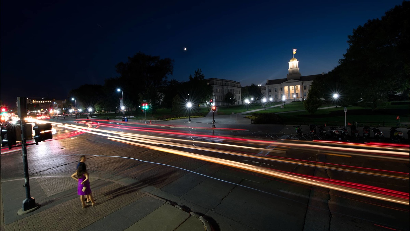 A photo capturing a street at night on the University of Iowa Campus